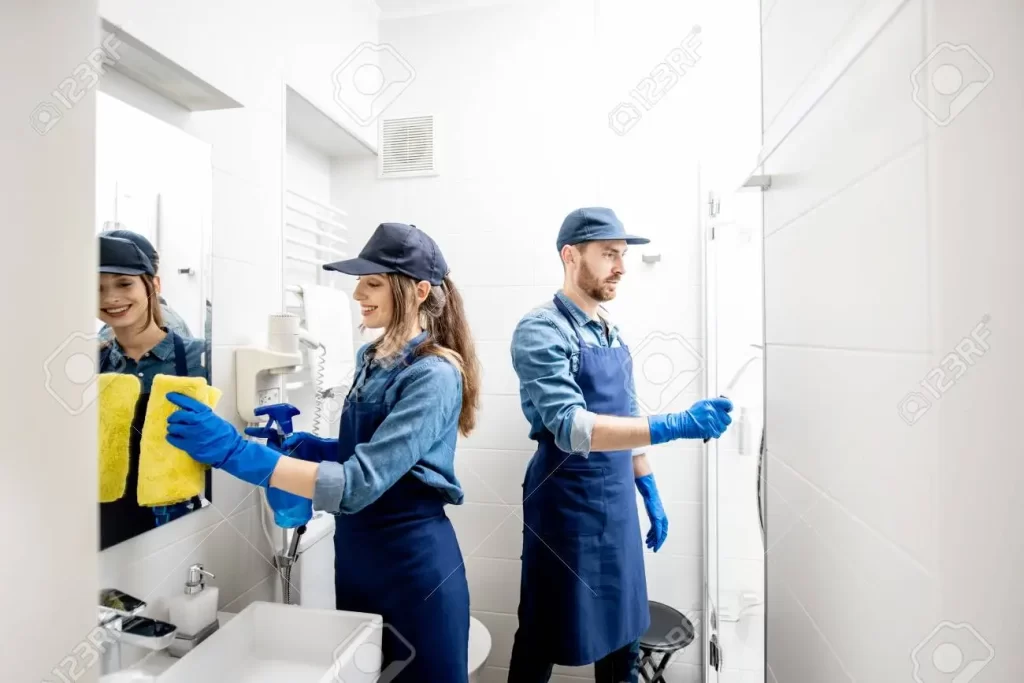 113098876 couple as a professional cleaners in blue uniform cleaning bathroom cleaning service concept 1